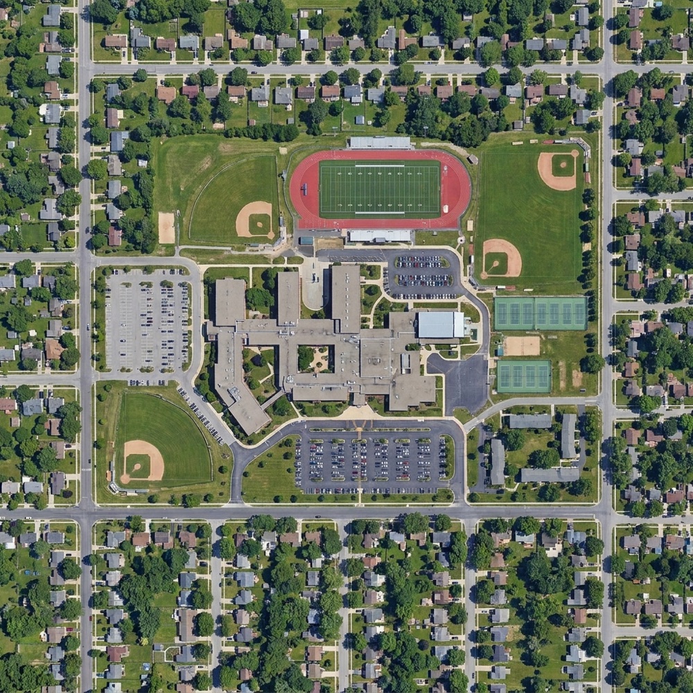 Aerial view of a school campus: managed School Zone inside the boundary, private Personal Zone outside